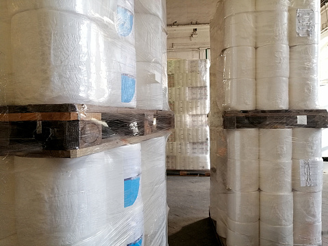 Distribution cardboard factory warehouse with cardboard stacks.