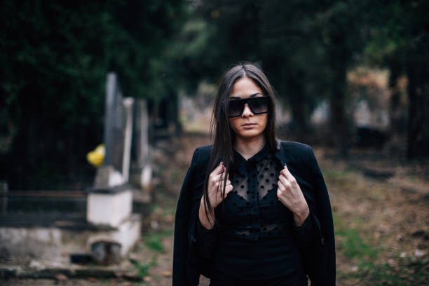 istock One young woman walking through cemetery 1288174841
