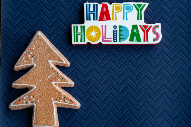istock Happy Holidays plaque message and a glitter gingerbread Christmas Tree on blue background 1288177165