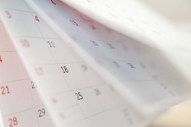istock Calendar page flipping sheet close up on office table background business schedule planning appointment meeting concept 1288177589