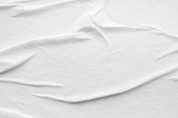 istock Blank white crumpled and creased paper poster texture background 1288177614