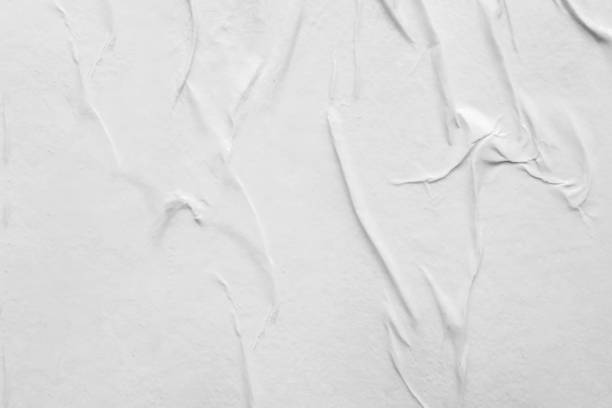 istock Blank white crumpled and creased paper poster texture background 1288177616