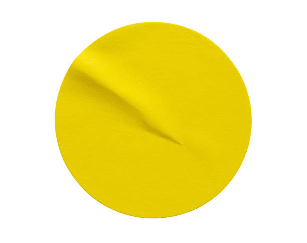 istock Yellow round paper sticker label isolated on white background 1288178164