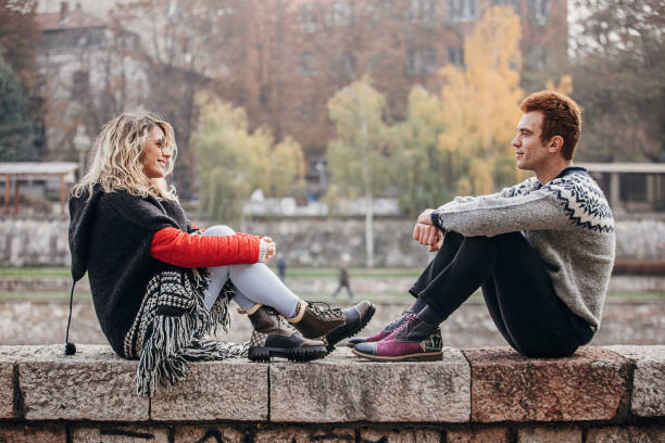 istock Modern couple sitting outdoors in city 1288182440