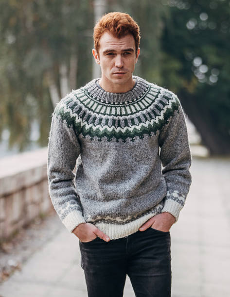 istock Man dressed in modern winter sweater walking outdoors 1288188063