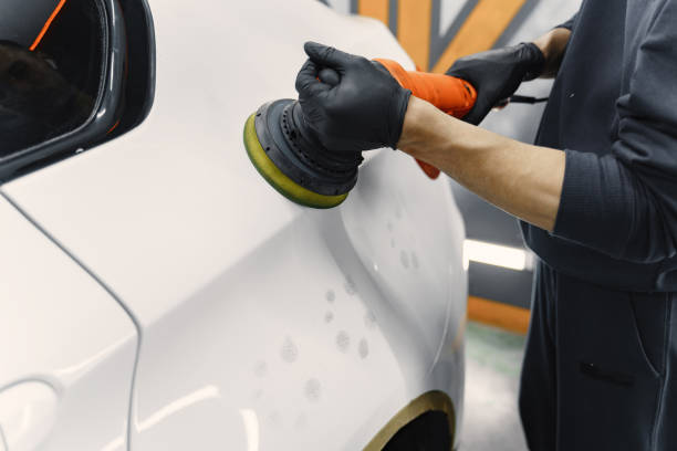 istock Man polish a car in a garage 1288190237