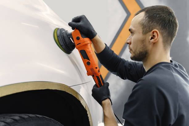 istock Man polish a car in a garage 1288190242