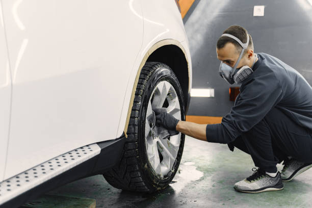 istock Man polish a car in a garage 1288190268