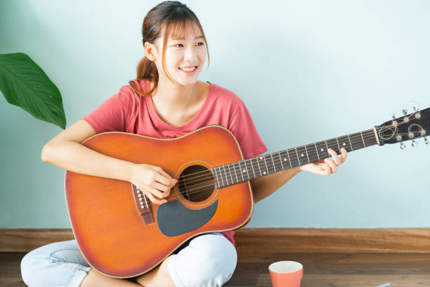 istock Woman playing guitar 1288195950