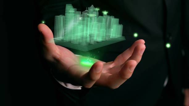 istock Businessman holds 3D city model showing augmented reality technology 1288197377