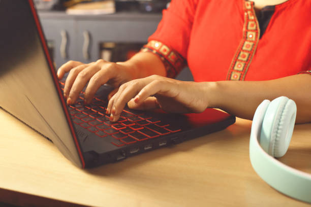 istock Indian woman working on laptop at home 1288198736