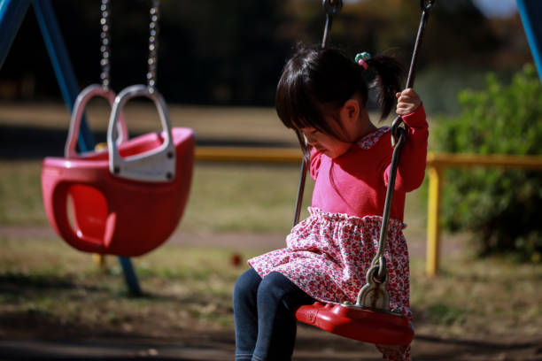 istock Girl playing on a swing alone 1288200306