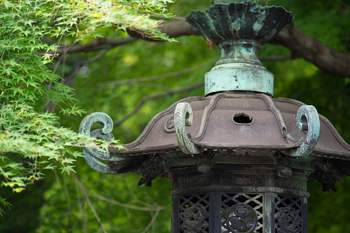A close-up of a bronze lantern at Toshogu Shrine in Ueno Park, Tokyo in May 2018. It is one of the important cultural properties designated nationwide.