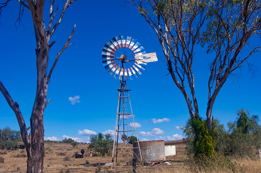 Outback Queensland grazing land in drought conditions, windmill suplying a little as needed