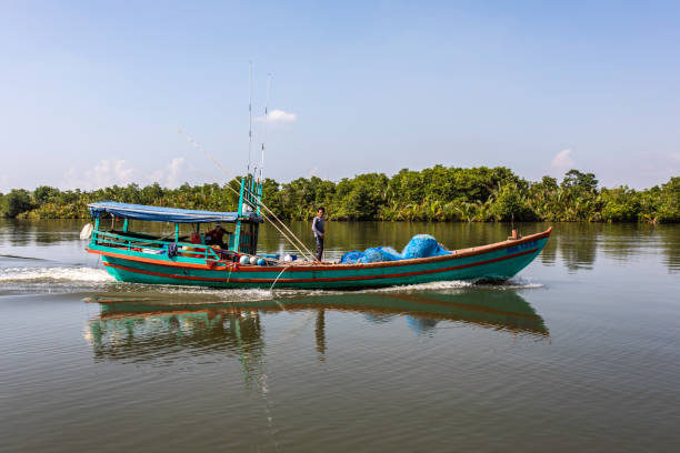 Cambodian Fishermen A Cambodian fishing boat returning to Kampot after a day of fishing in the Gulf Of Thailand. kep stock pictures, royalty-free photos & images