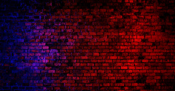 istock Vintage grunge brick wall texture background with red and blue lighting effect. 1288205702