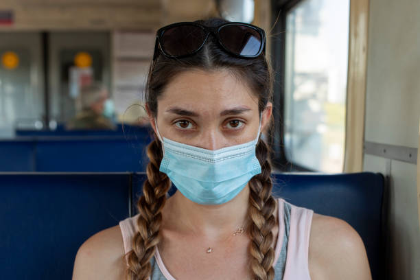 istock A girl in a protective mask in a subway car 1288208169