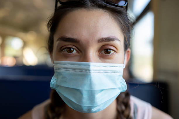 istock A girl in a protective mask in a subway car 1288208178