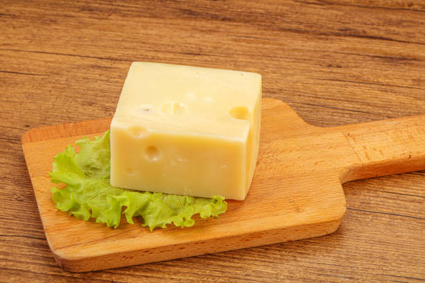 istock Emmental cheese over wooden board 1288214754