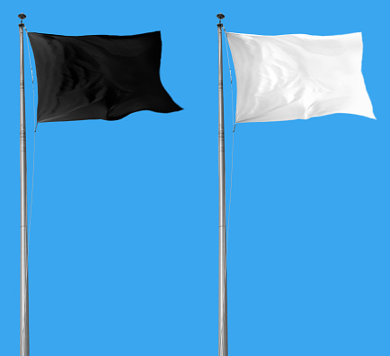 White and black flags attached to a flagpole waving over blue sky