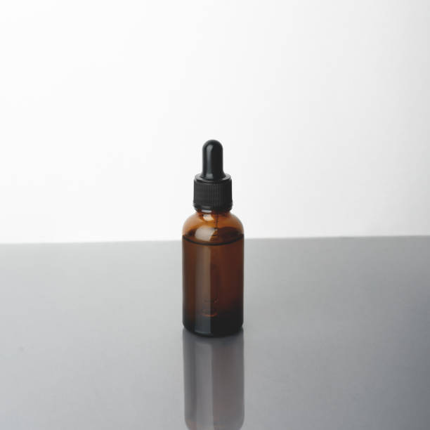 istock A glass dropper bottle on the beige background. 1288215097