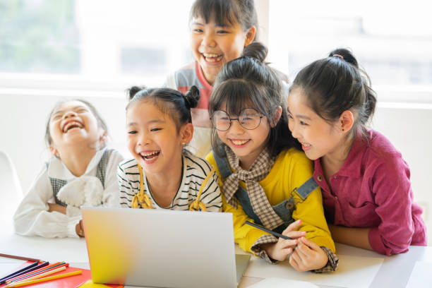 Children watching video on laptop