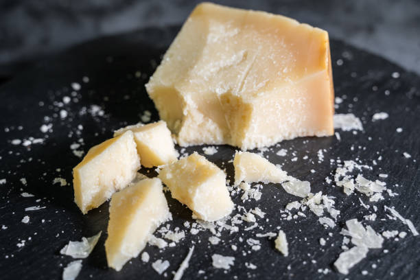 istock Italian Cheese on black stone background 1288216478