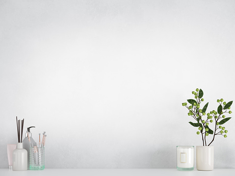 Minimal home decoration. Flower,  makeup accessories on white table, shelf with white wall.