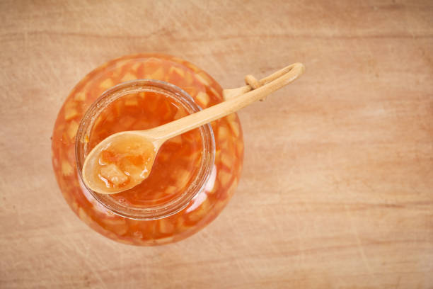 istock Orange homemade jam on wooden background. Top view. 1288217895