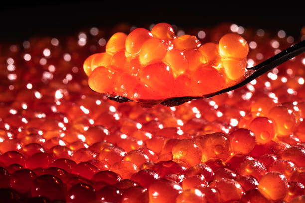 istock Red caviar in spoon on dark background. 1288218712