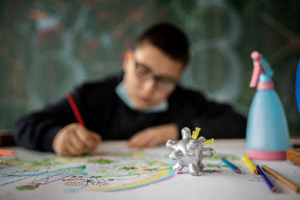 istock Young Boy drawing Covid-19 theme in school 1288220305