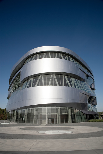 Stuttgart, Germany - October 14, 2019: Modern Architecture Mercedes-Benz Museum under deep blue sky. The Mercedes Benz Museum  is an automobile museum which contains more than 160 vehicles. The Museum opened for the public in 2006 and is since then one of the most futuristic buildings in Stuttgart. Thousands of people from all over the world visit it every year.