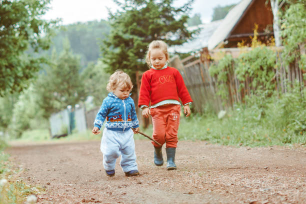 istock sister and brother walking down the street 1288221426