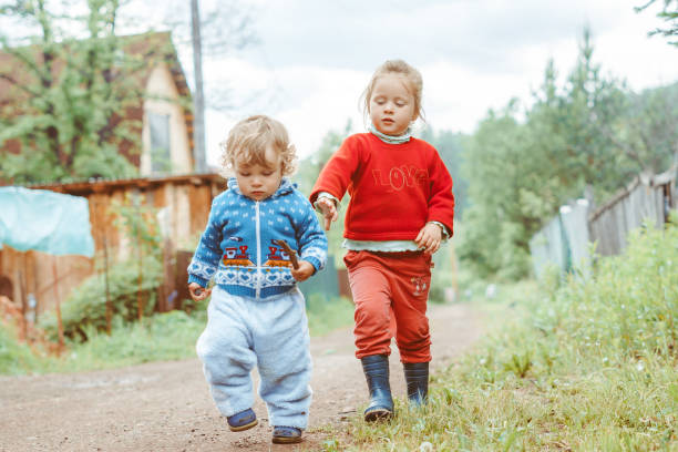 istock sister and brother walking down the street 1288222021