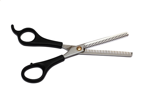 Hairdresser black scissors close up, isolated on a white background