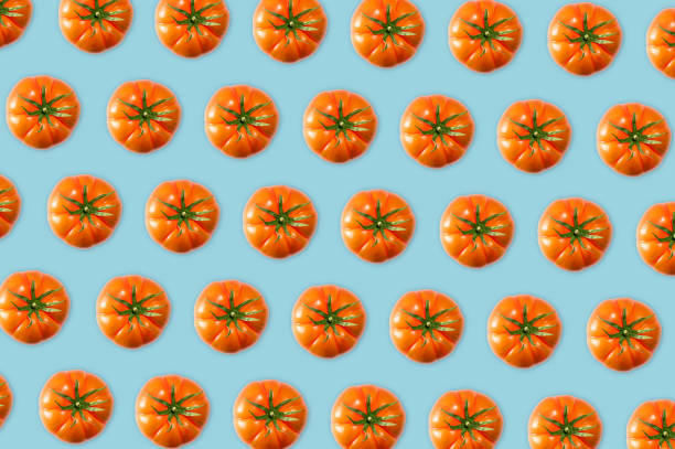 istock Top view of organic tomatoes on turquoise background 1288223811