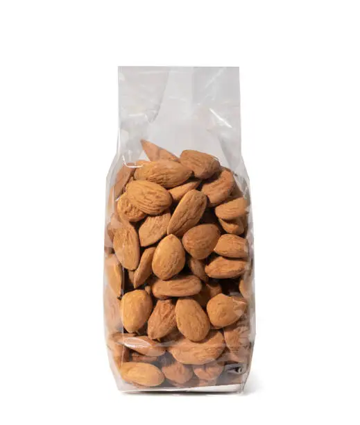 Nuts in Plastic Package, Almonds without Shell - Close-Up - Isolated on White Background