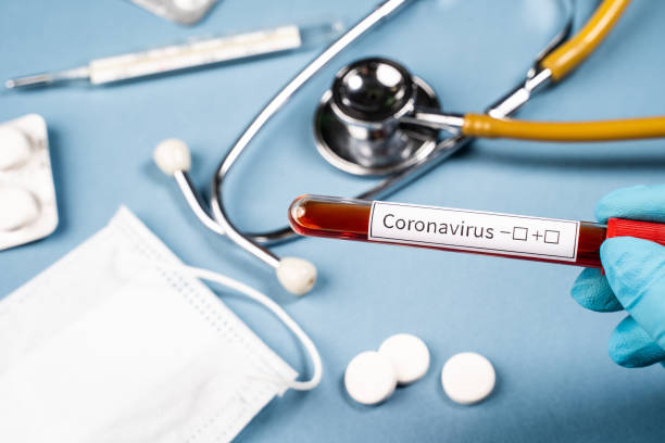 istock Hand holds test tube with blood for Coronavirus test 1288226682