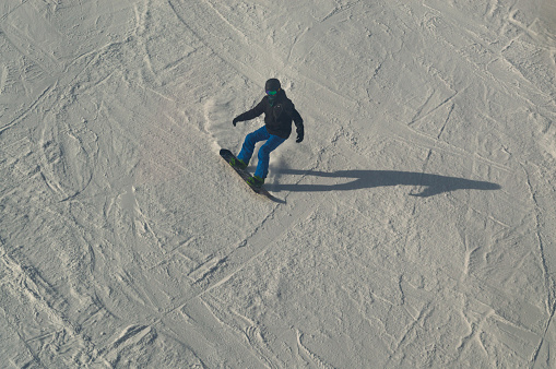 Zhangjiakou, Hebei Province / China - February 13, 2015: Snowboarder at Genting Olympic resort, snowy mountain resort which will host skiing and snowboarding events for Beijing Winter Olympics 2022