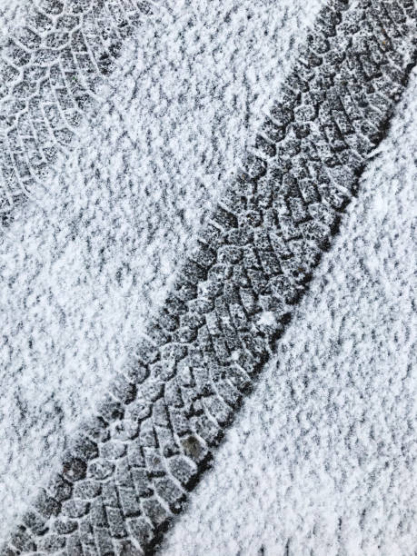 istock Car tire tracks in fresh snow. 1288227738
