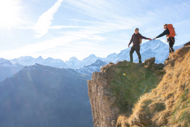 istock Hikers relax on sunny mountain ridge in the morning 1288229857
