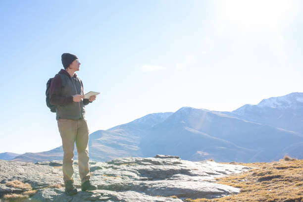 istock Hiker relaxes on sunny mountain ridge in the morning 1288230113