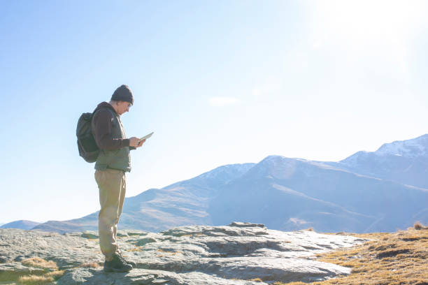 istock Hiker relaxes on sunny mountain ridge in the morning 1288230118