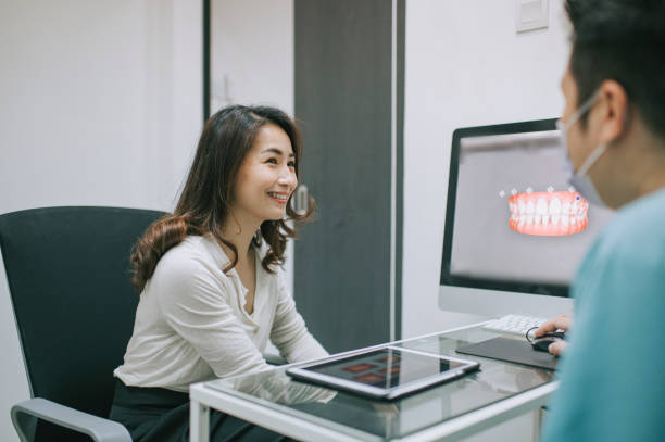 istock asian chinese male dentist explaining Tooth X-Rays To A Patient 1288230146