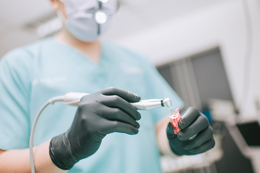 asian chinese dentist preparing Dental prosthetist tool implant