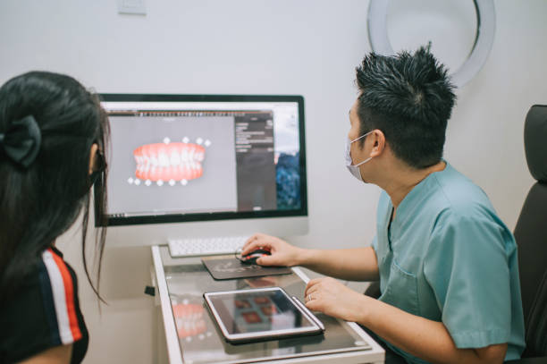 istock asian chinese male dentist explaining Tooth X-Rays To A Patient 1288230225
