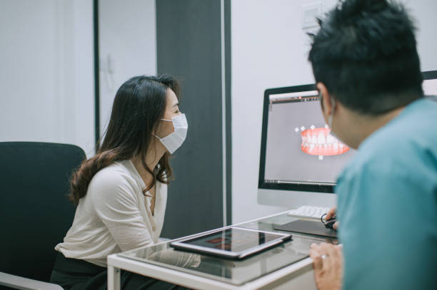 istock asian chinese male dentist explaining Tooth X-Rays To A Patient 1288230230