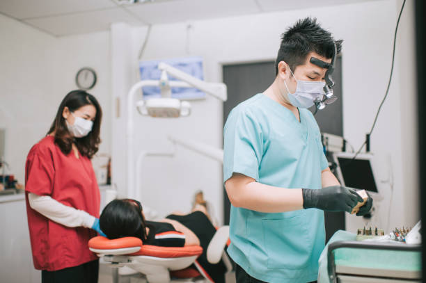 istock asian chinese dentist preparing Dental prosthetist tool implant 1288230242