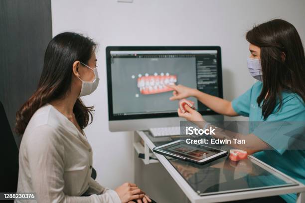Asian Chinese Female Dentist Explaining Tooth3d To A Patient Stock Photo - Download Image Now