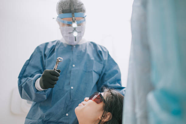 istock asian chinese dentist pulling out bad tooth from patient with pliers 1288230418